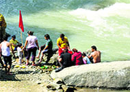 Revellers enjoy near the Beas in Kullu