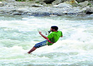 a tourist enjoys adventure sport in the Beas