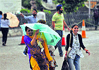 People run for cover as it rains in Shimla on Monday morning.
