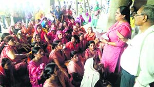 Anganwadi workers stage a dharna outside the Deputy Commissioners office in Kurukshetra on Monday.