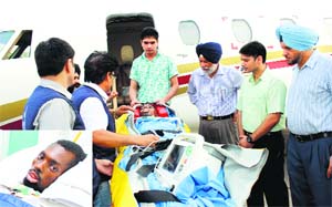Yannick Nihangaza (inset), who slipped into coma after being assaulted, being flown to Burundi in an air ambulance from Patiala on Monday