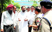 BSP leader Sukhwinder Kotli being stopped by ADCP Naresh Dogra from reaching the Circuit House in Jalandhar on Monday. 