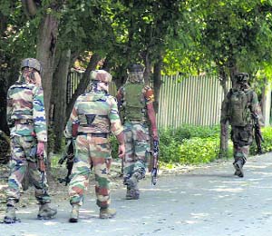 Army personnel carry out a search operation at Qaimoh in Kulgam district on Monday.