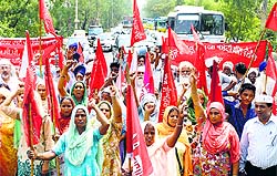 Farmers hold a demonstration at the Rajpura-Patiala highway on Monday