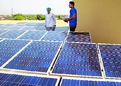 A farmer shows his solar panel in Bathinda