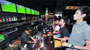 Fans watch the live telecast of a soccer match at a pub in Chandigarh. 