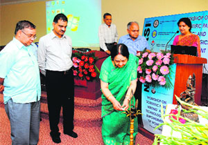 Prof Manju Sharma, former Union Secretary, biodiversity board, lights the lamp at the UCOST workshop held at Graphic Era University on Tuesday; (extreme left) Vijay Kumar Dhoundhiyal, UCOST Director General, looks on.