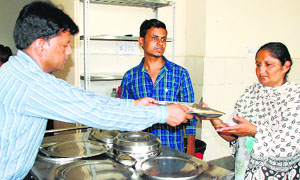 A patient at the Civil Hospital in Ambala served food under the Annapurna scheme.