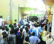 Local residents gather outside the pickle unit in Hisar. 