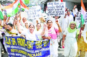 Members of the PoJK Refugee Front protest in Jammu on Tuesday. 