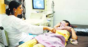 A doctor examines a patient at a hospital.