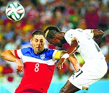 Clint Dempsey of the U.S. locks horn with Ghana's John Boye during the Group G match