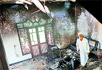 A man at his charred home following clashes between Muslims and Buddhists in the town of Alutgama on Tuesday.