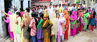 People wait for their turn to cast vote in the phase I of the panchayat poll at Chakrata in Dehradun on Wednesday.