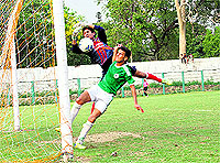 Players try to net a goal at the Pavilion ground in Dehradun on Wednesday.