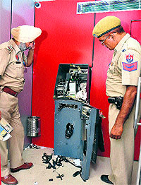 Cops check the damaged ATM machine of the Union Bank of India at Bashirpura in Jalandhar on Wednesday.