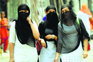Girls cover their faces on a sunny day.