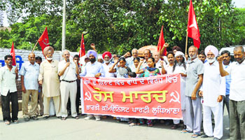 Activists of the district unit of the CPI hold a protest march in Ludhiana on Wednesday. 