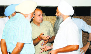 AAP leader Manish Sisodia (centre) interacts with party workers in Ludhiana.