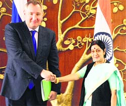 Russian Deputy Prime Minister Dmitry Rogozin (L) shakes hands with External Affairs Minister Sushma Swaraj during a meeting in New Delhi on Wednesday. 