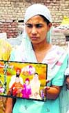 Harjit Kaur, wife of a Punjabi youth stuck in Iraq at Jalal Usma village on Wednesday.