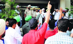 Activist of the Shaheed Kartar Singh Sarabha Lok Bhalai Manch protest outside a hotel where AAP leaders met party workers in Ludhiana on Wednesday. 