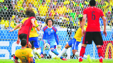 Mexico's goalkeeper Guillermo Ochoa (C) making one of his spectacular saves against Brazil on Tuesday night.