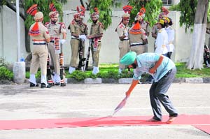 A man cleans the carpet before the arrival of Union Minister Harsimrat Kaur Badal in Bathinda on Thursday.