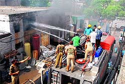Firemen try to control the flames at a factory unit in the Industrial Area, Phase II, Panchkula, on Thursday