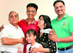 Tricity topper Shubham Goel shares his success with his family members in Panchkula on Thursday