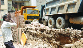 Victim Sadhu Rams son breaks down near the spot where the wall collapsed at Majlis Park in Adarsh Nagar, North Delhi, on Thursday.