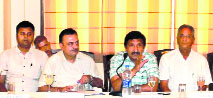 Industries Minister Mukesh Agnihotri with industry representatives in Nalagarh on Thursday.