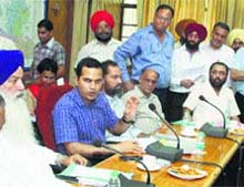 Deputy Commissioner Kamal Kishore Yadav holds a meeting with political leaders and officials for the rationalisation of collector rates in Jalandhar on Thursday. 