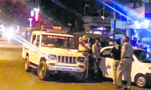 Police officials challan vehicles during a midnight raid at the railway station in Ludhiana on Thursday.