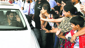 Female fans wave at actor Varun Dhawan in Ludhiana on Thursday.