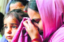Reena Choudhary, wife of Rajesh Kumar, who is one among Many Indians stuck in Iraq, at MIran sahib near Jammu on THursday.