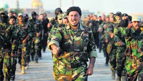Volunteers in the newly formed Peace Brigades participate in a parade near the Imam Ali shrine in the southern Shiite city of Najaf.