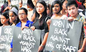 Activists of Women in Black protest against rape on women, in Bengaluru on Thursday.
