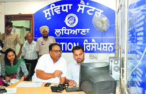 Chief Secretary Sarvesh Kaushal (second from left) checks some records on a computer at the Suvidha Centre, Mini-Secretariat, in Ludhiana on Friday