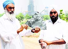 Villagers show sharp iron objects that fell on their houses and caused damage