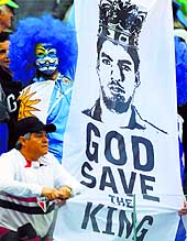 A Uruguay fan holds up a picture of Luis Suarez mocking English defeat on Thursday