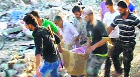 People carry a body of blast victim in Hama on Friday.