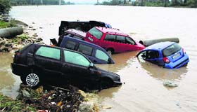 Damaged cars are seen following a heavy flooding in the city of Varna, Bulgaria, on Friday. Torrential rains and floods hit Bulgaria on Thursday, killing at least 10 persons, cutting off electricity, blocking roads and sparking evacuations.