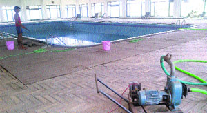 Water being pumped out of the swimming pool at the Gymkhana Club in Panchkula.
