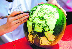 A cook carving an image of Fuleco the Armadillo, the official mascot of the 2014 FIFA World Cup, on a watermelon in Shenyang, northeast China's Liaoning province. Brazil is hosting its first World Cup since 1950 from June 12 to July 13, 2014.