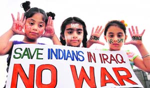 Girls give the message of "Save Indians In Iraq" in Amritsar on Sunday.