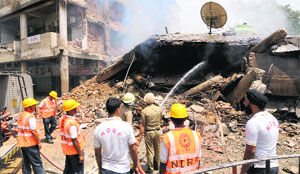 Members of the National Disaster Response try to douse the fire at Sector 17 in Chandigarh.