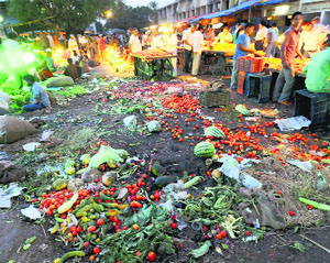 Vegetable and fruit waste lie in the middle of the road.