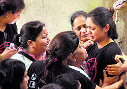 Residents of the Campa Cola Society weep in Mumbai on Sunday