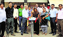 Officials of the State Bank of Patiala hand over a rickshaw to Jinder Kaur in Muktsar on Saturday